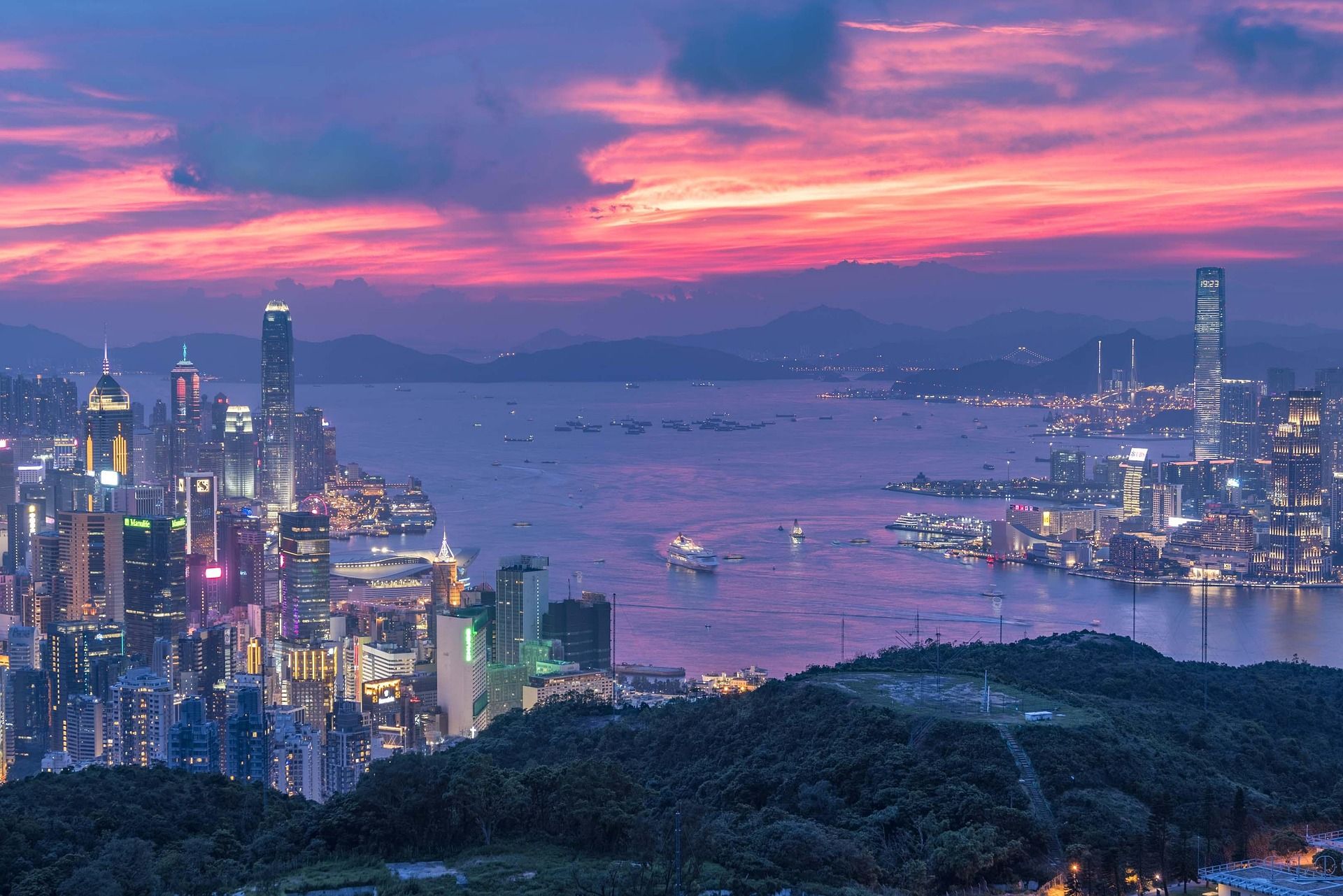 Hong Kong skyline and Victoria Harbour at dusk, seen from the hills